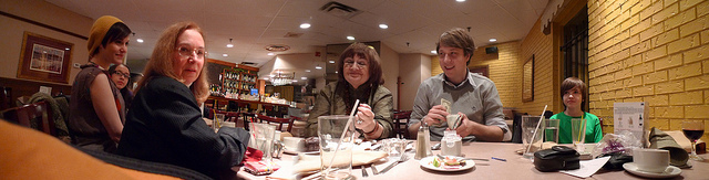 photography of a family around a restaurant table