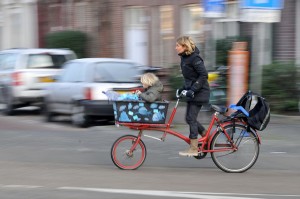 pan motion photograph of Amsterdam woman on uniqu bike by FaceMePLS https://flic.kr/p/9fE5Gj