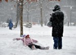 photograph of girl making a snow angel while it is snowing by Kevin Burkett https://flic.kr/p/7oXcEa